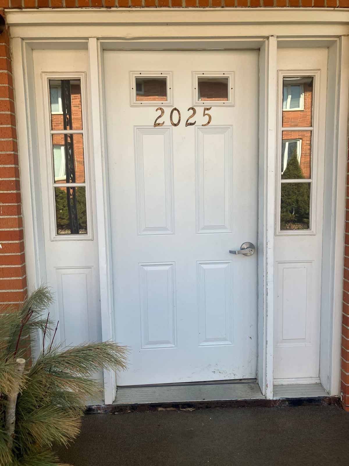 White door with address number 
