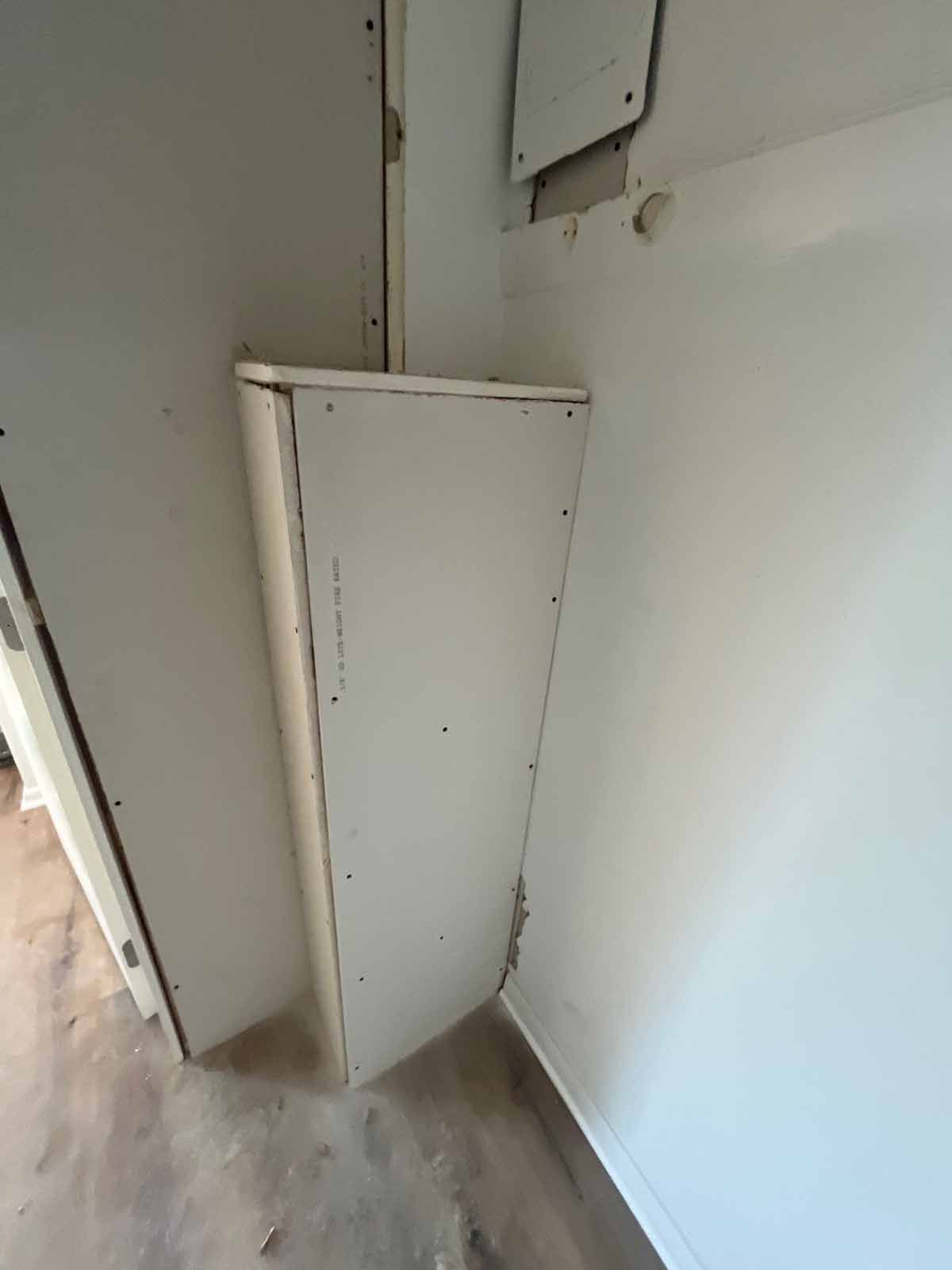 A drywall corner shelf built into a wall. It is light in color.