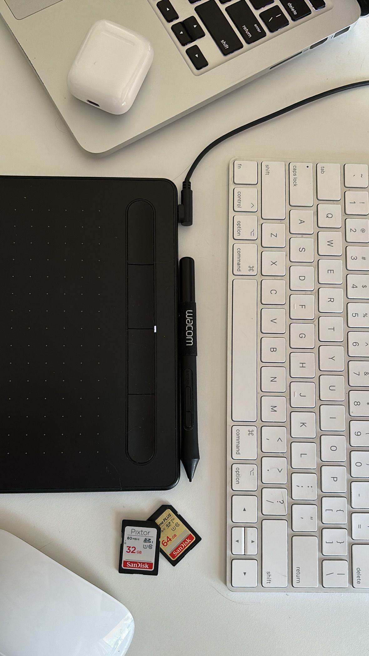 laptop, airpods, and keyboard