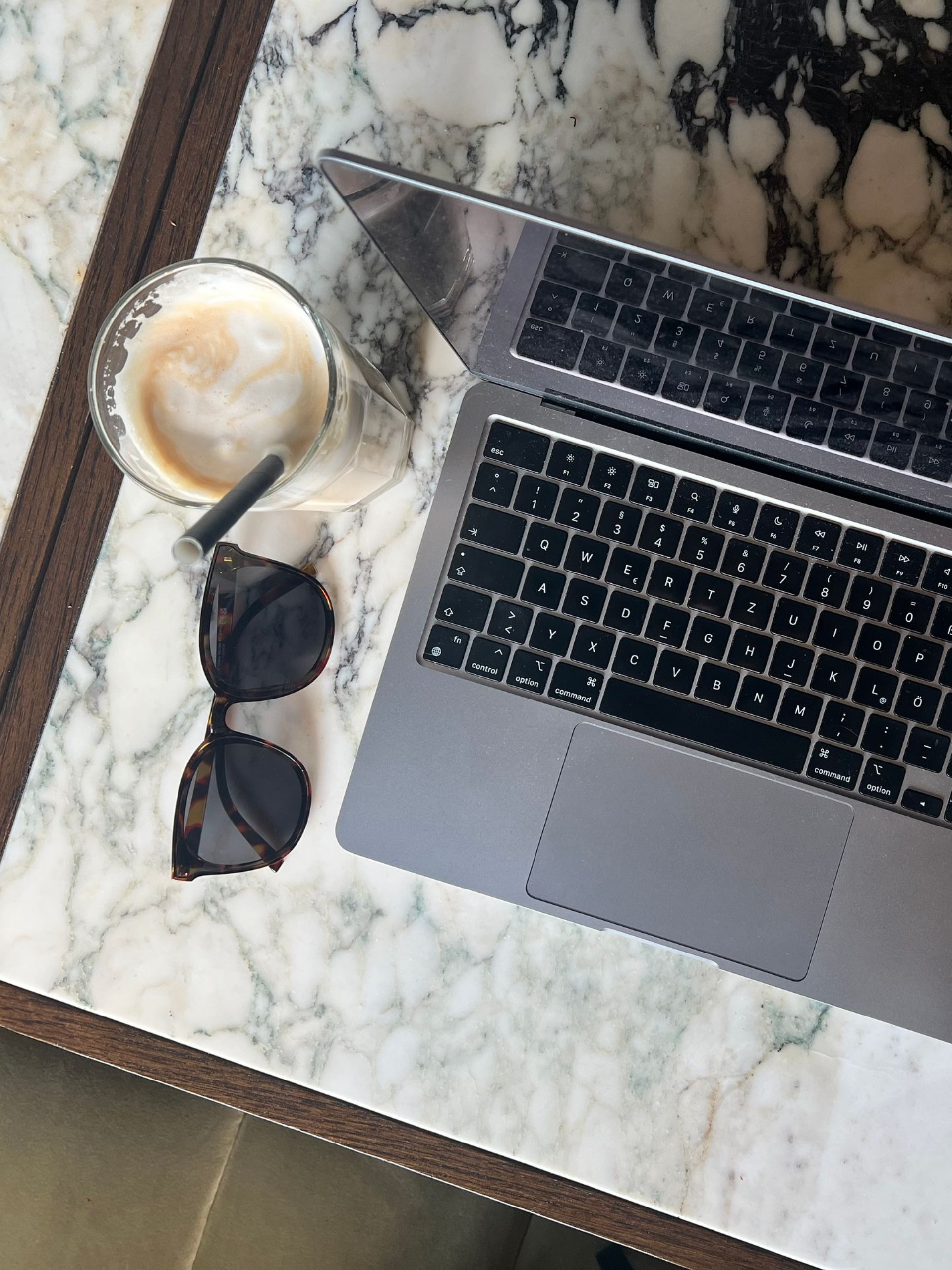 laptop and coffee on marble table