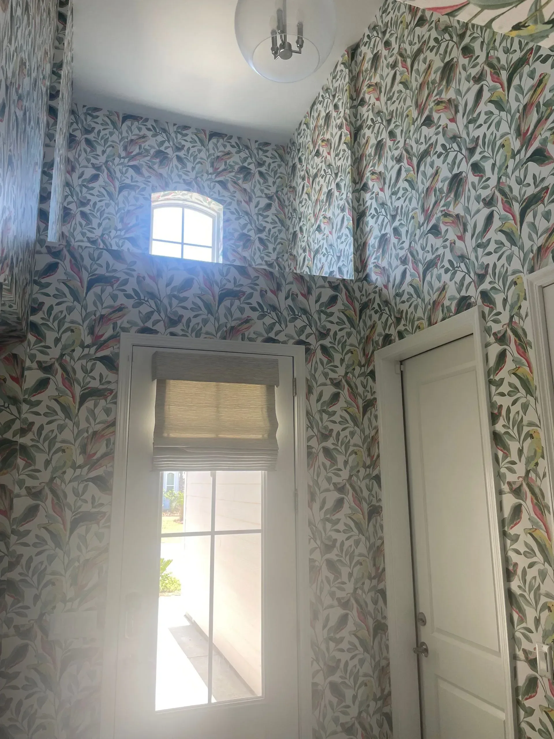 White sectional sofa in a living room with gray walls and built-in white shelving.