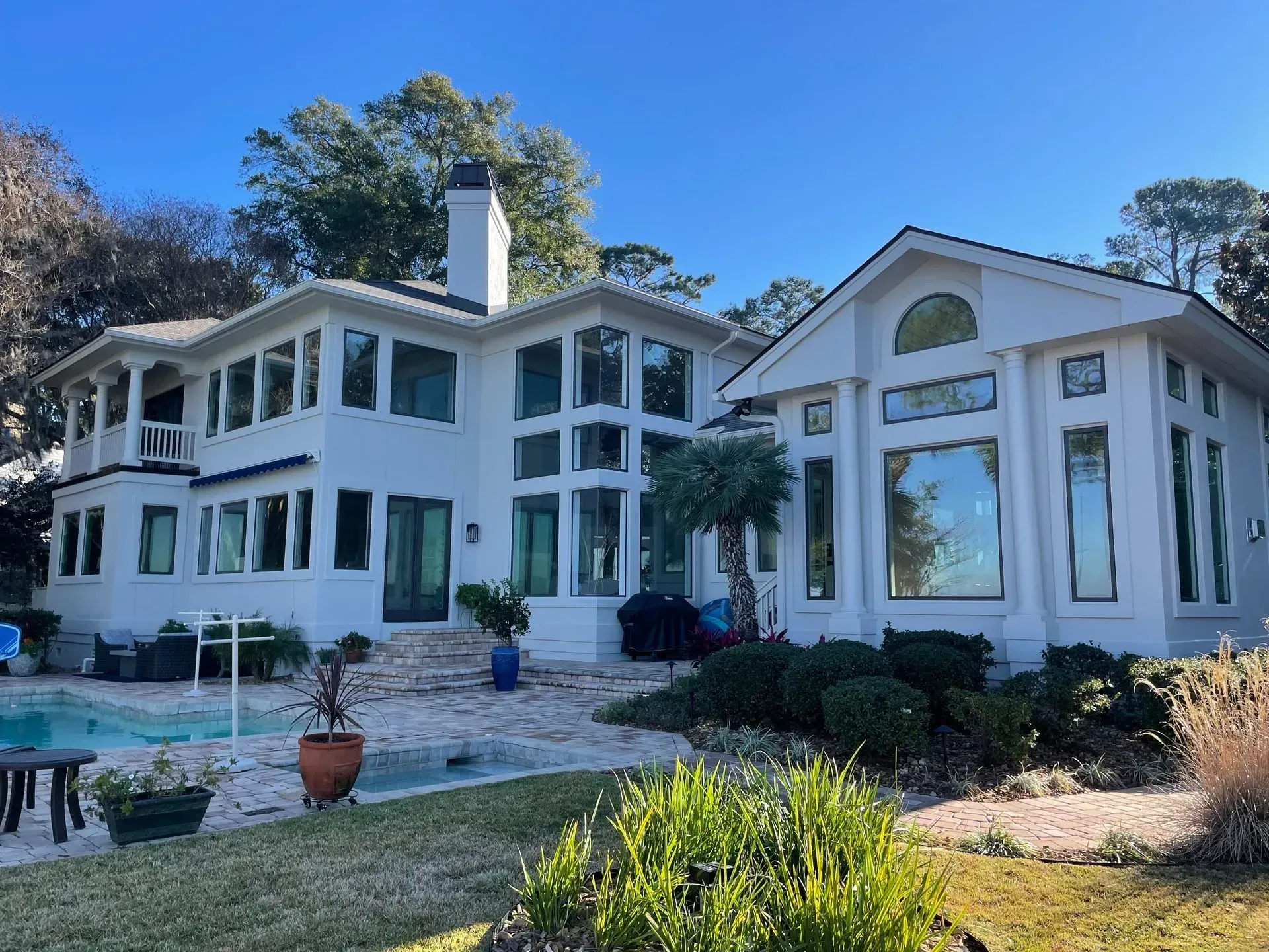 White sectional sofa in a living room with gray walls and built-in white shelving.