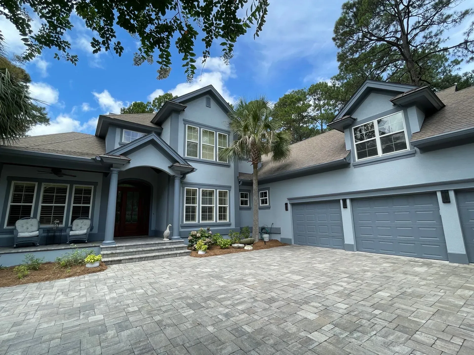 White sectional sofa in a living room with gray walls and built-in white shelving.