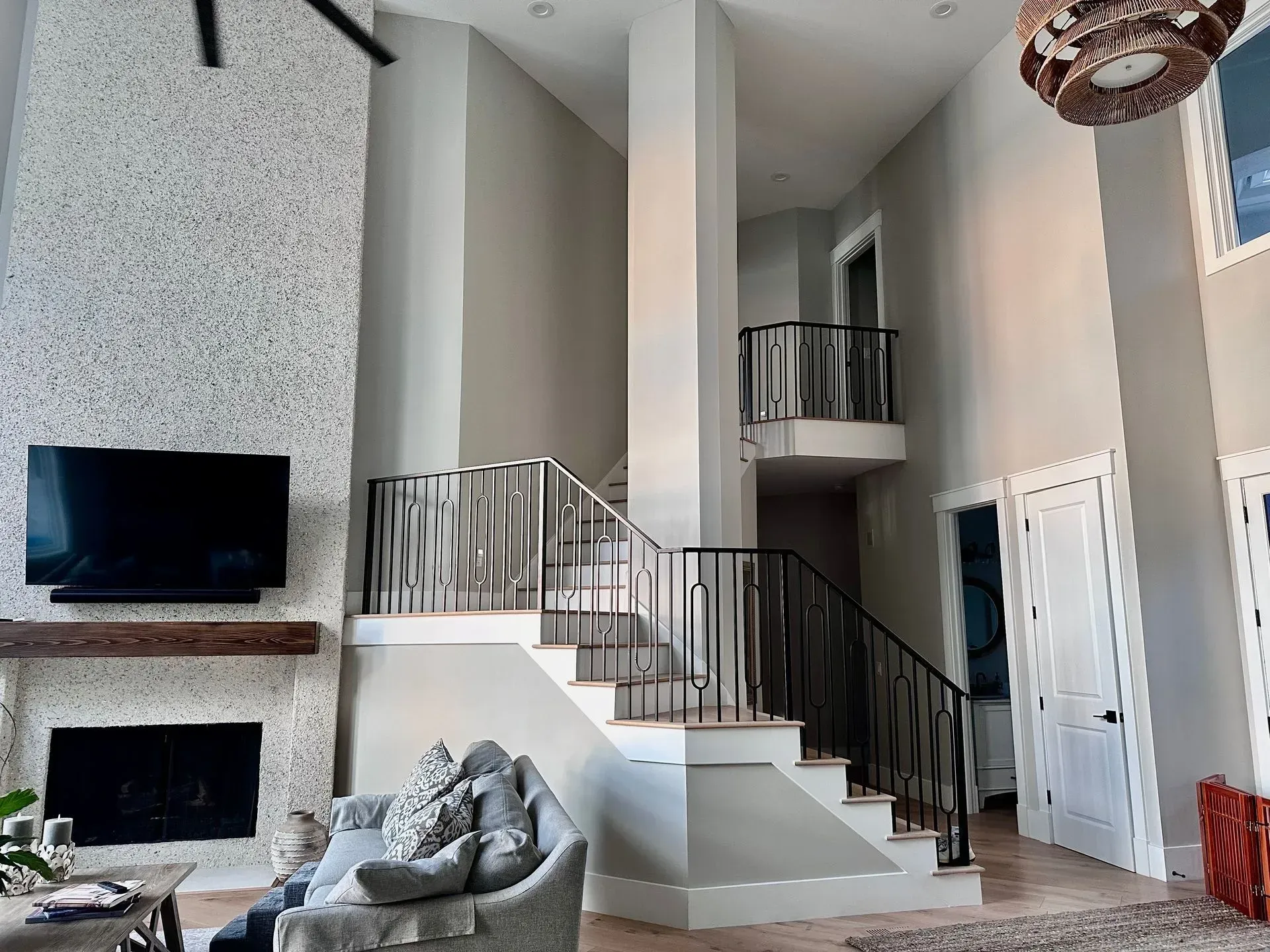 White sectional sofa in a living room with gray walls and built-in white shelving.