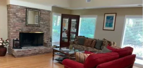 A living room with two couches, a coffee table, and a built-in bookshelf.