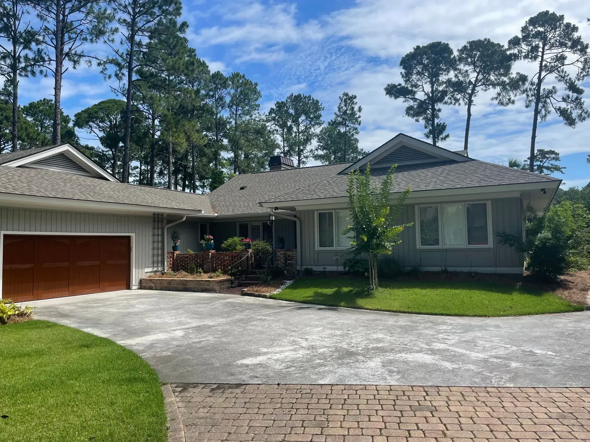 White sectional sofa in a living room with gray walls and built-in white shelving.