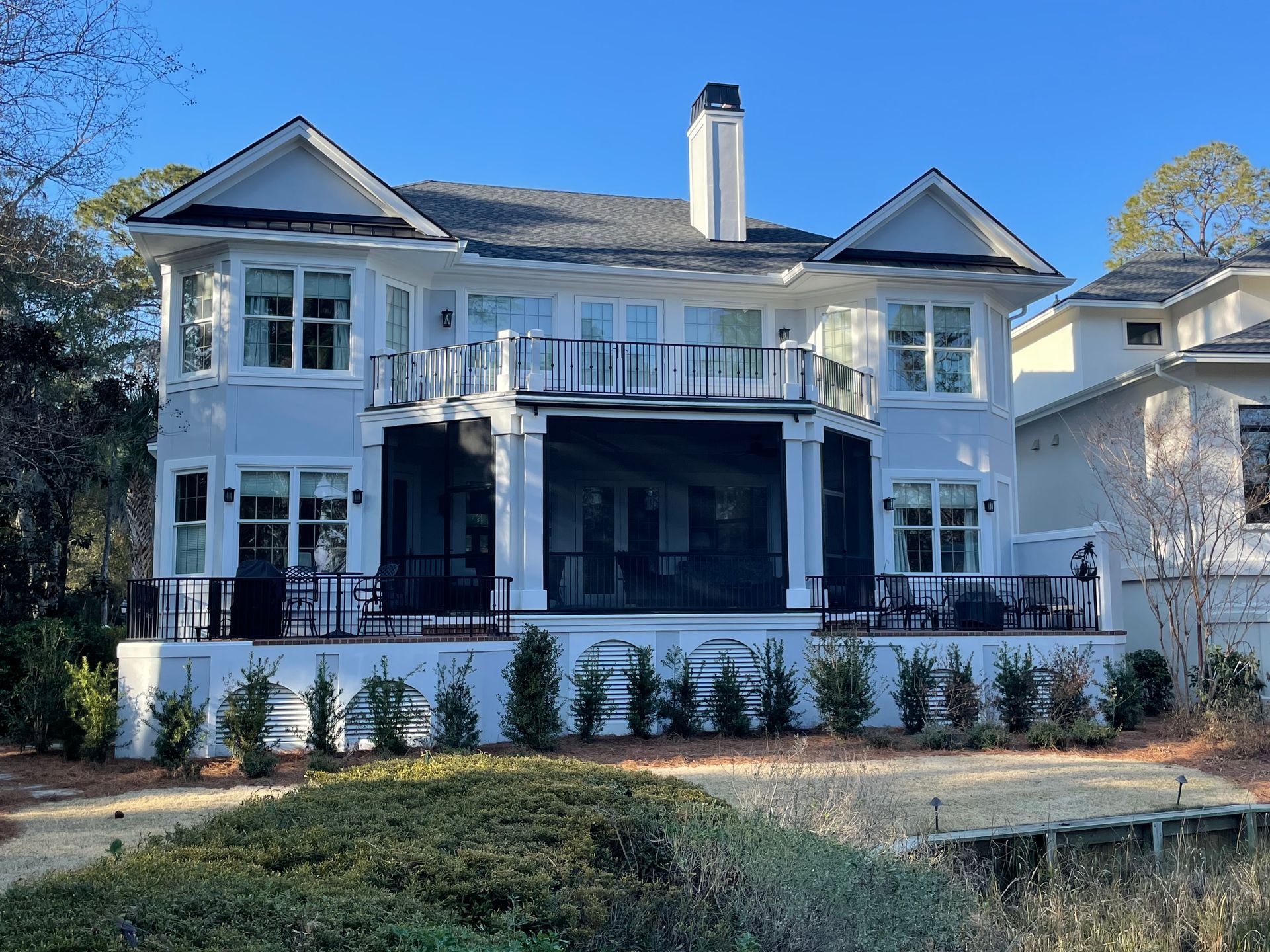 White sectional sofa in a living room with gray walls and built-in white shelving.