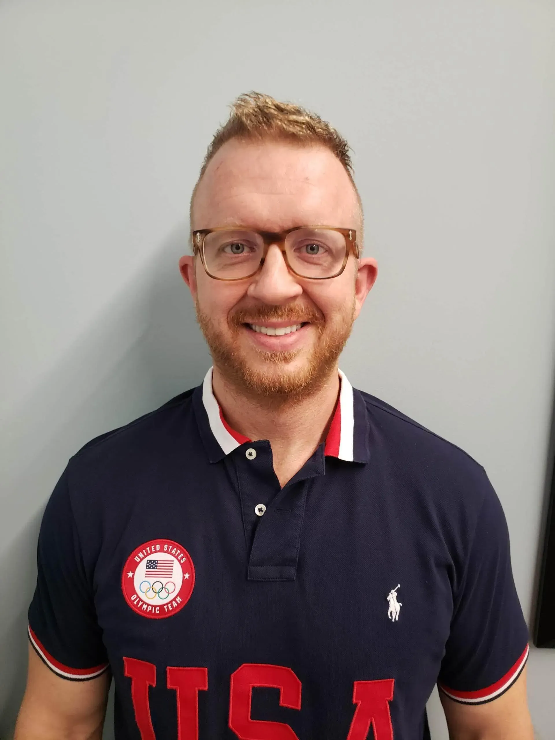 A man wearing a polo shirt with the word usa on it