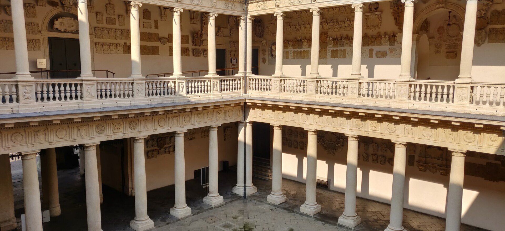 An aerial view of a building with columns and balconies.