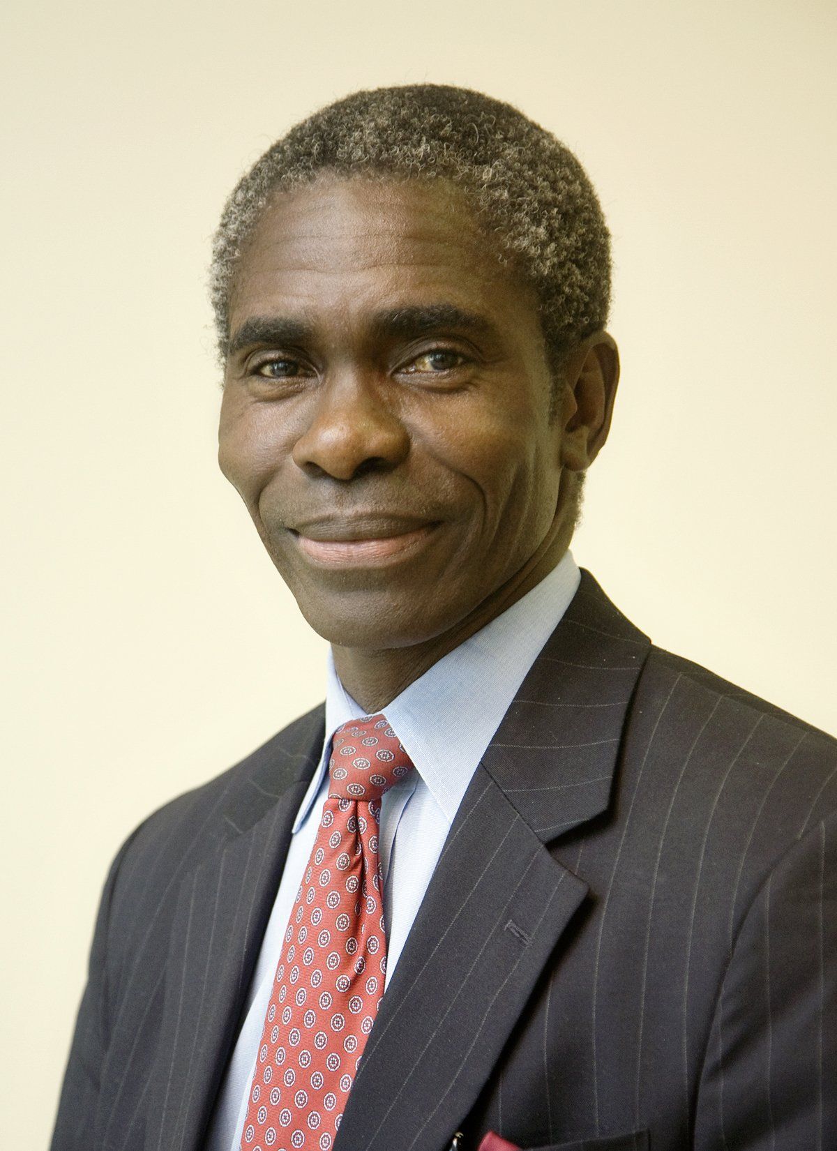 A man in a suit and tie is smiling for the camera