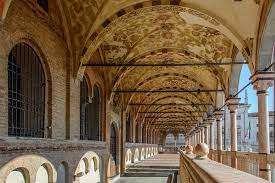 A long hallway with arches and columns in a building.