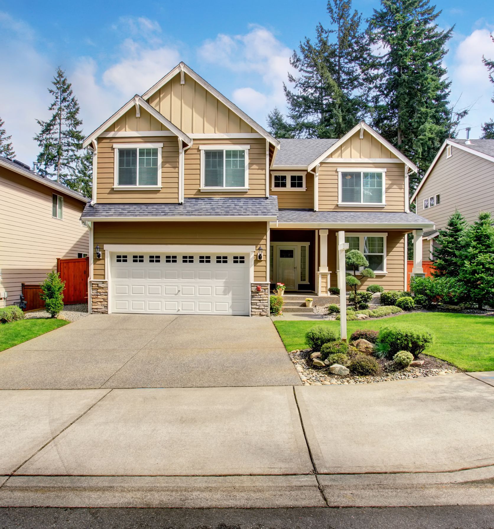 The front of a house with a white garage door