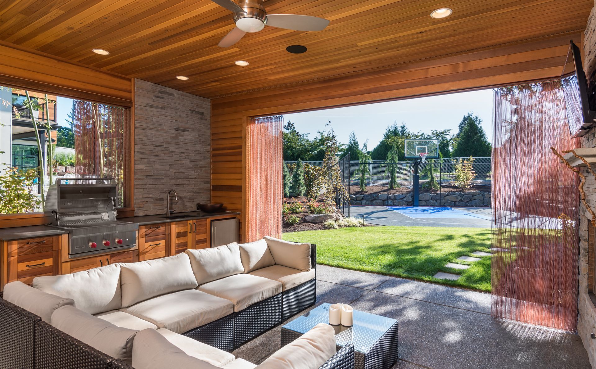 A living room with a lot of furniture and a ceiling fan