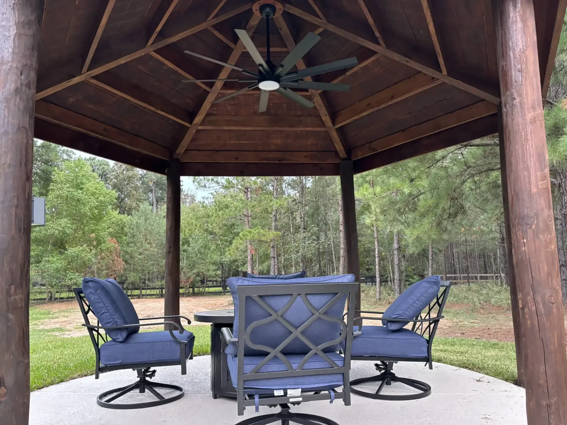 A gazebo with a table and chairs underneath it
