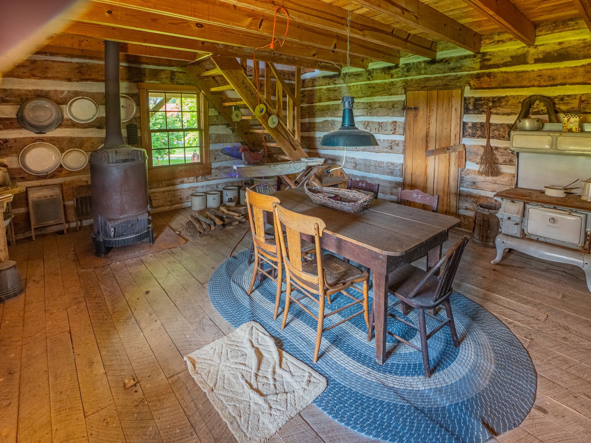 a dining room in a log cabin with a table and chairs