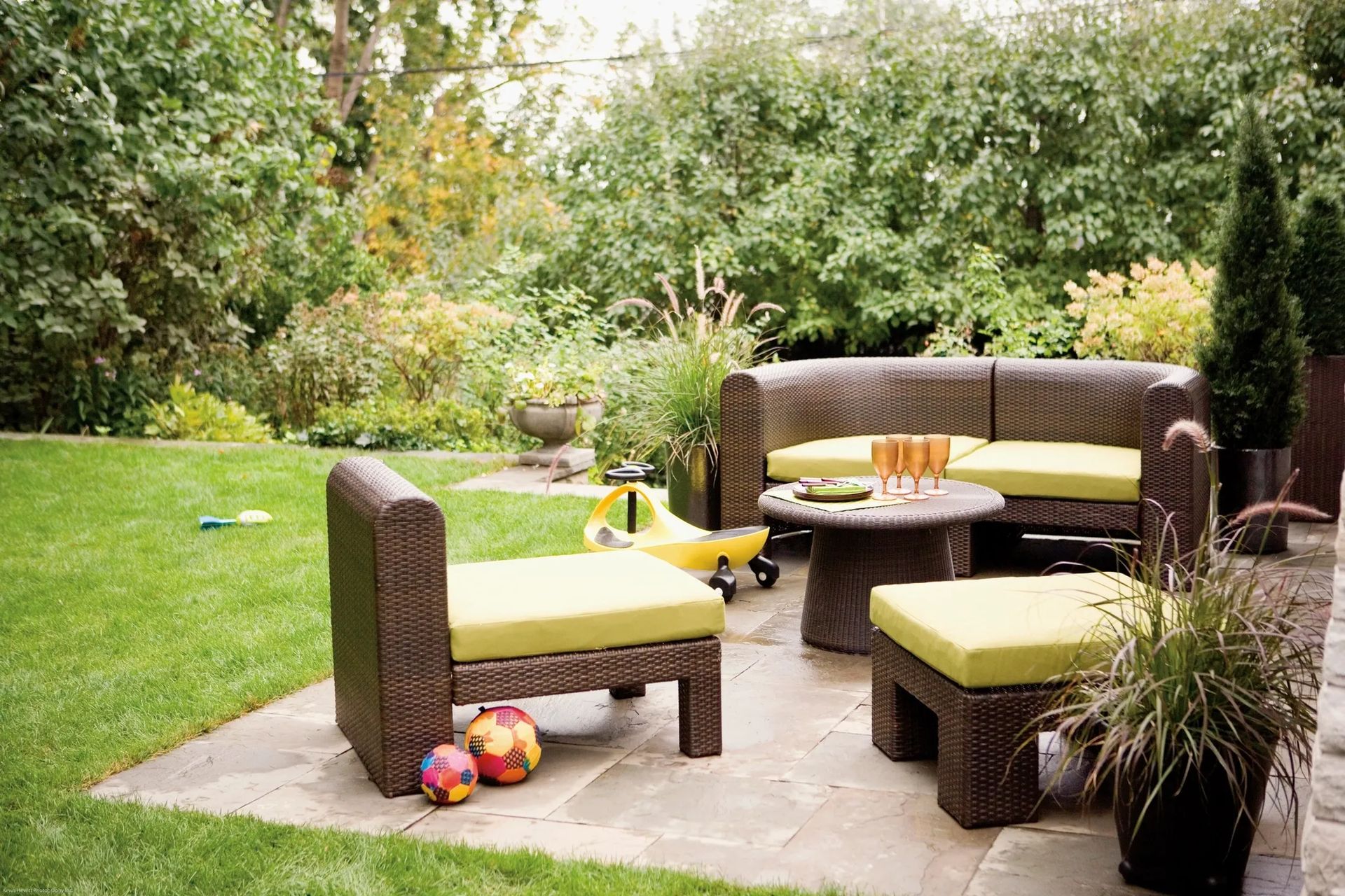 A patio with a couch , chairs and a table