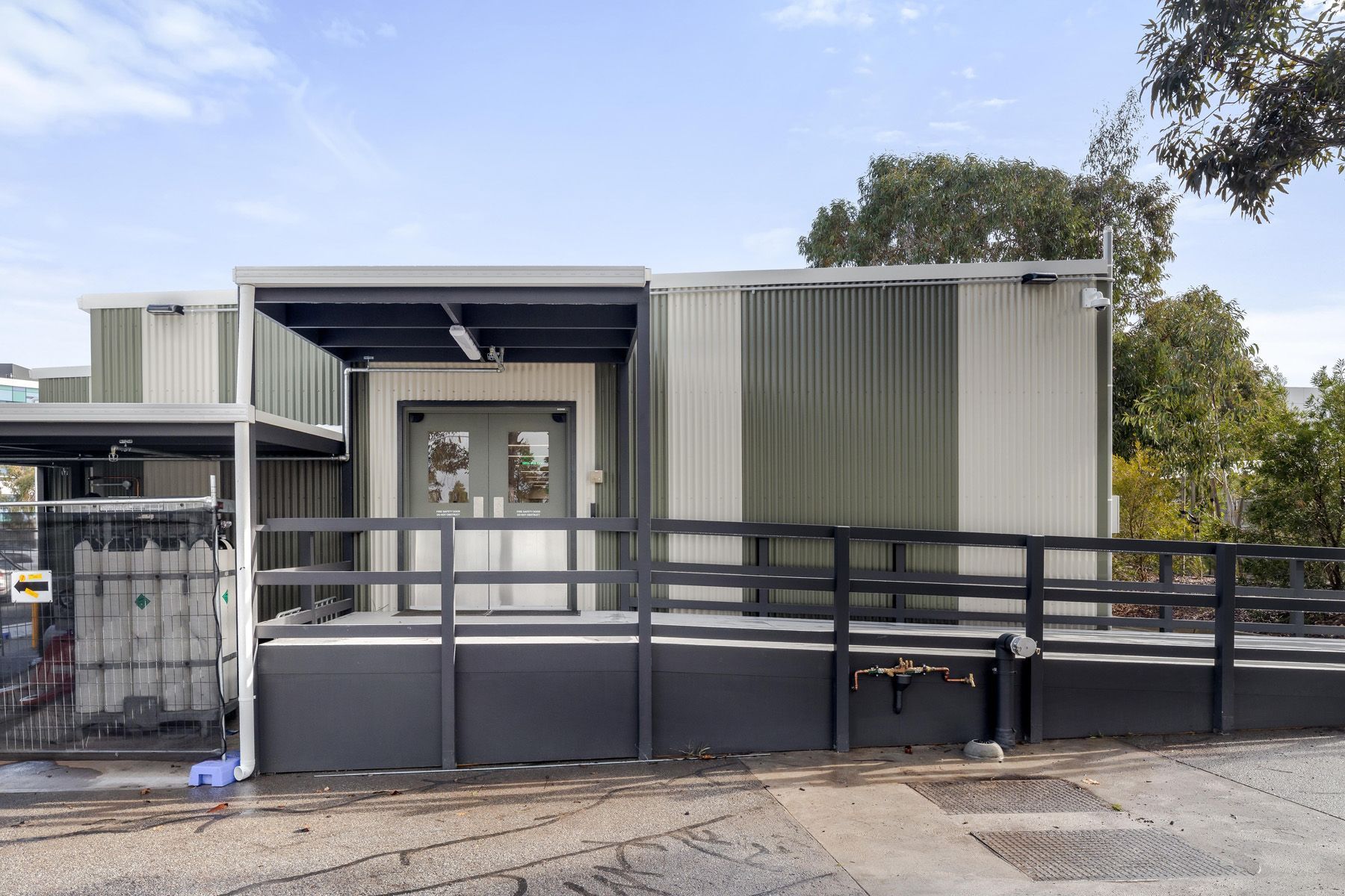 A building with a ramp and a fence in front of it.