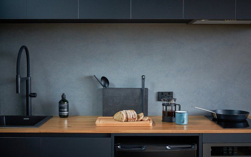 A kitchen counter with a loaf of bread on it.