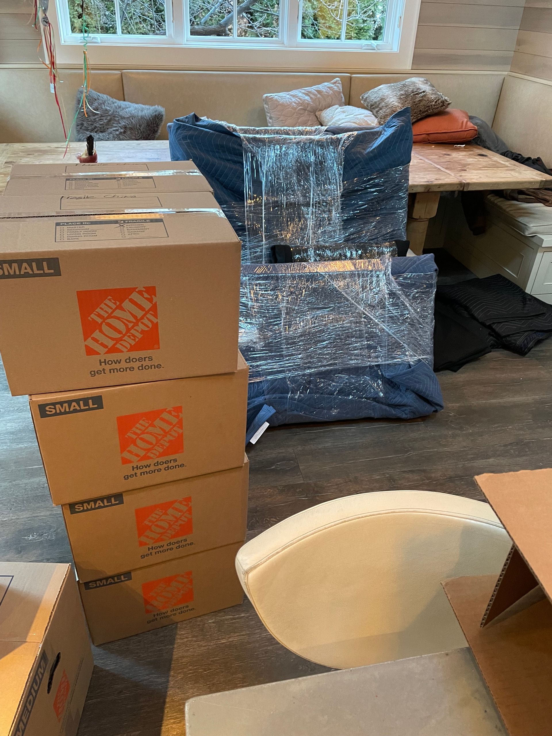The home depot boxes are stacked on top of each other in a living room.