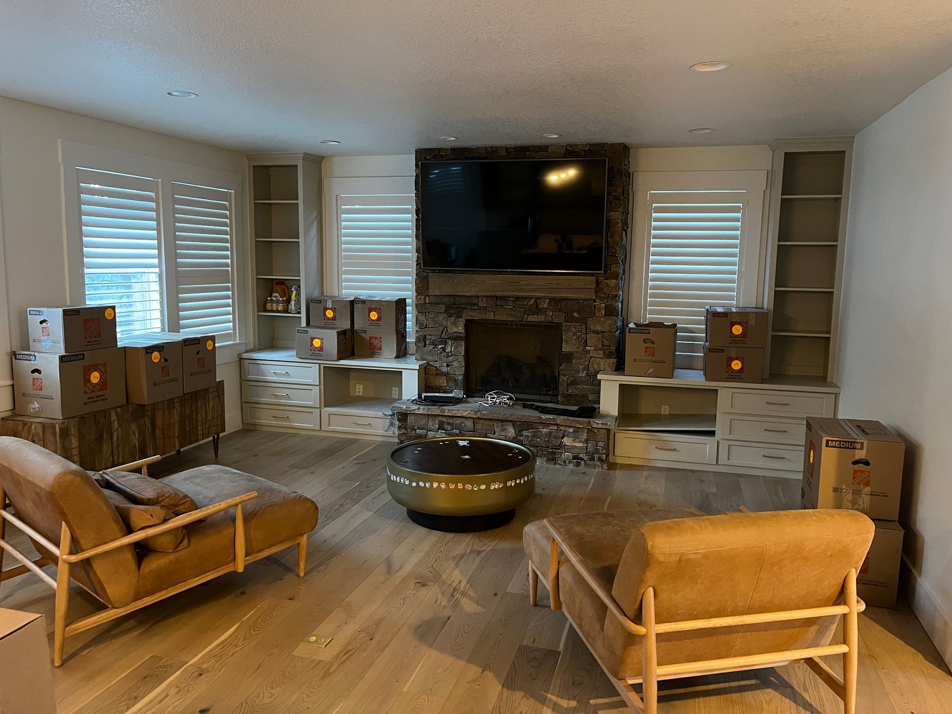A man is standing next to a bunk bed in a room.