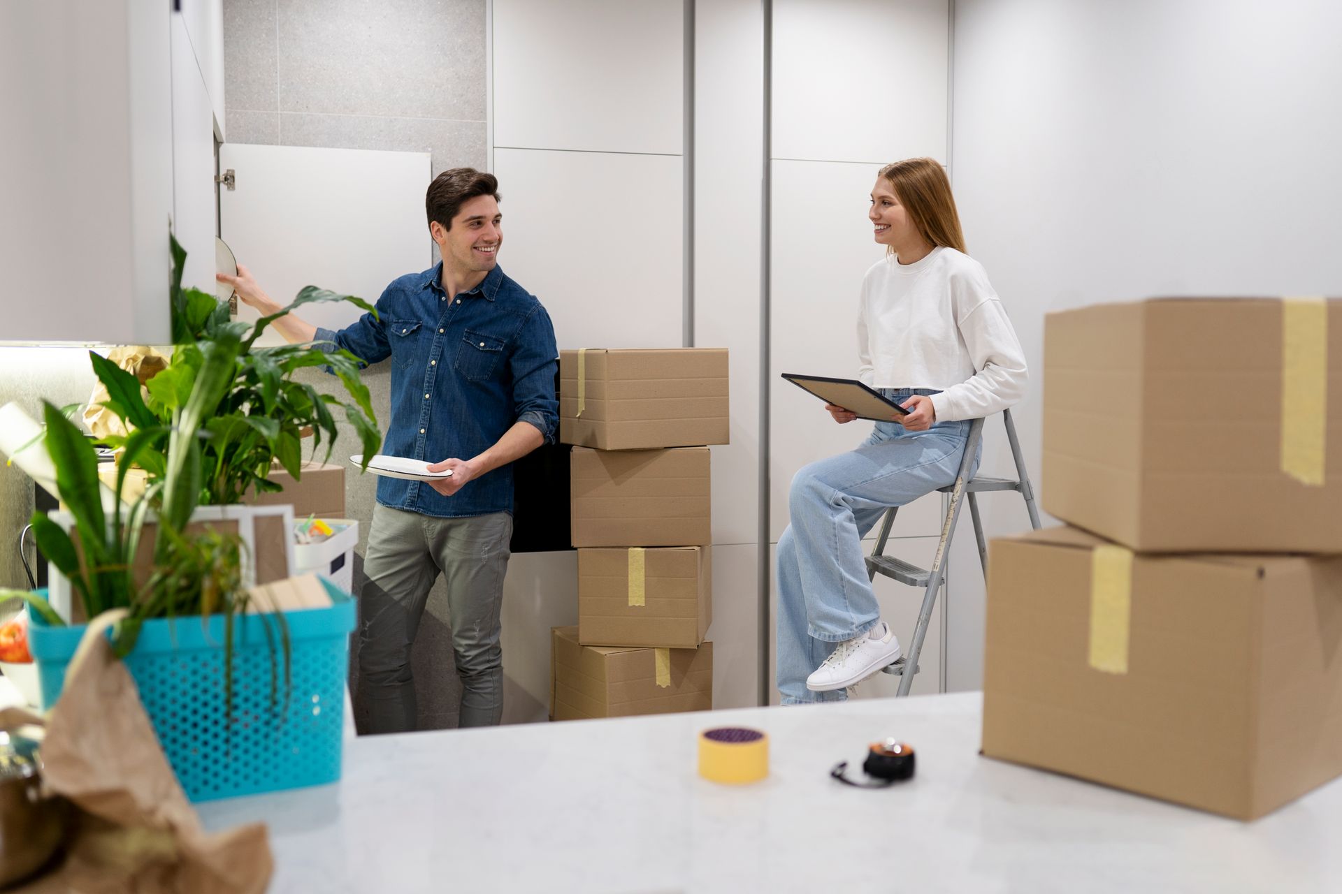 A man and a woman are moving into a new home.