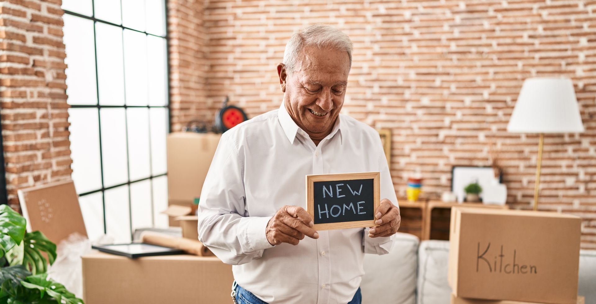 Older adult smiling, holding 