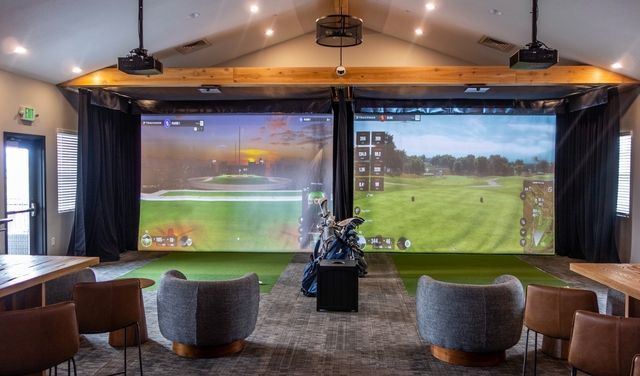 A close up of a bride in a wedding dress holding her veil.