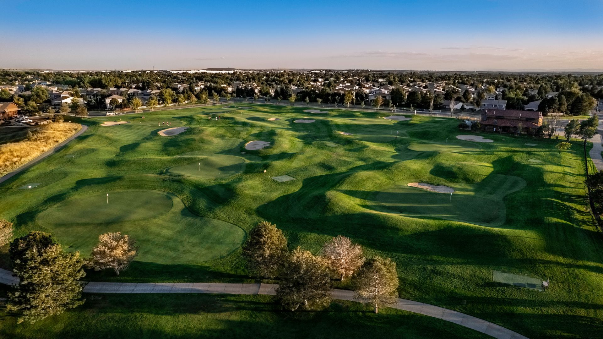 A close up of a bride in a wedding dress holding her veil.