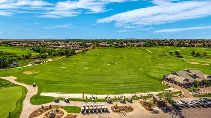 A view of a golf course from inside a building.