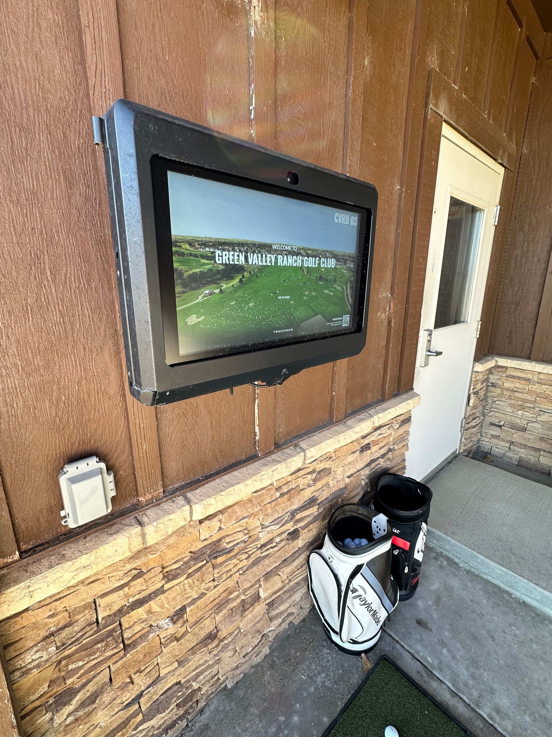 A bride in a wedding dress is sitting on the ground holding a bouquet of flowers.