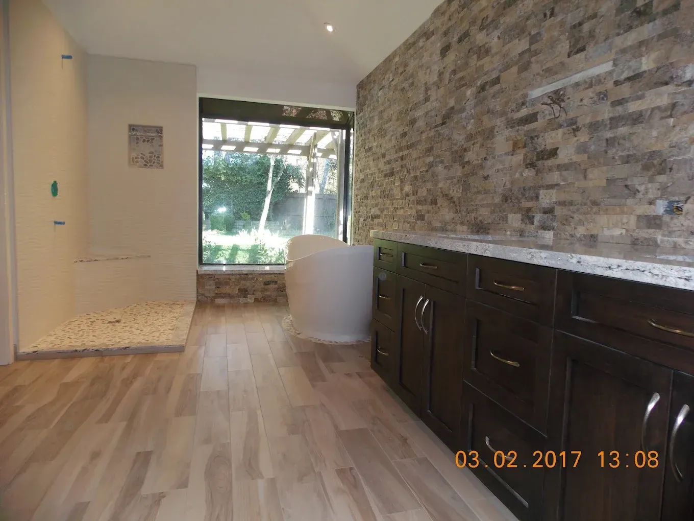 A bathroom with a tub and a walk in shower.