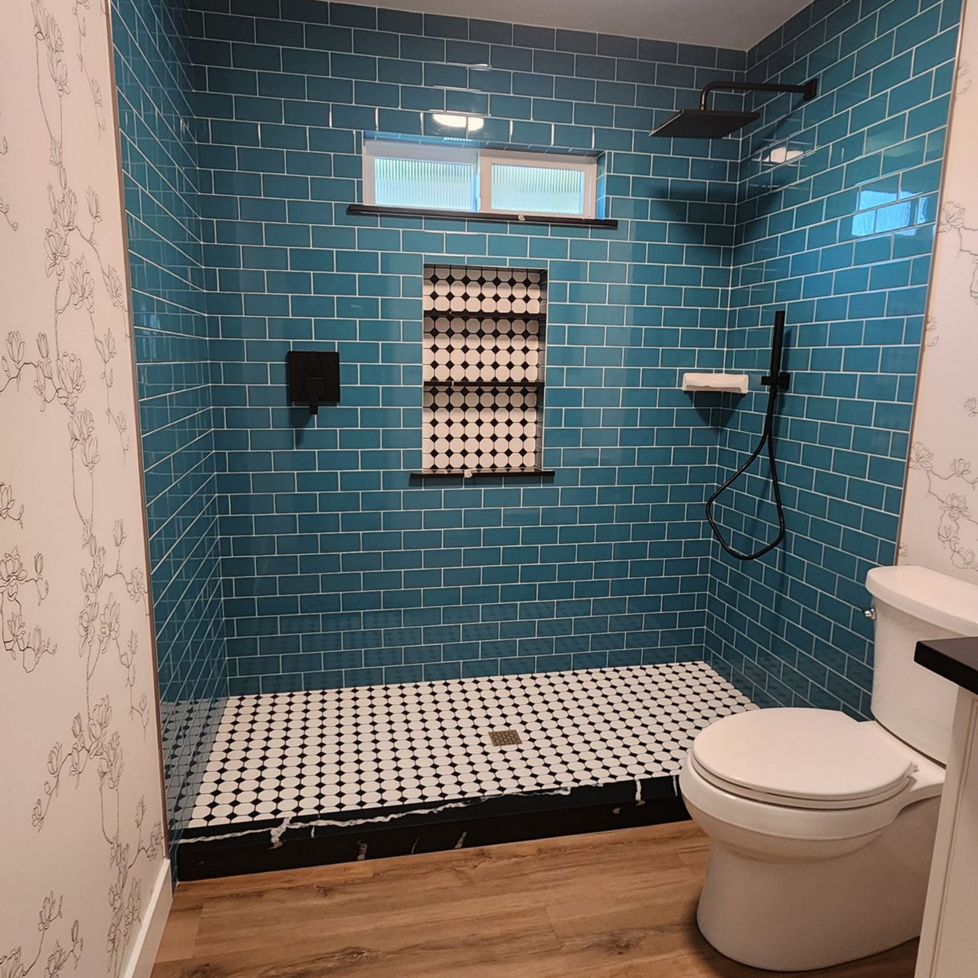 A living room with a stone fireplace and a flat screen tv