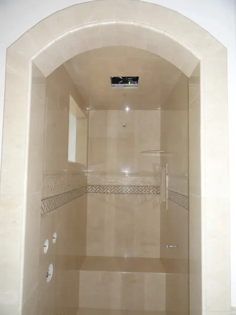 A bathroom with a shower and a window.