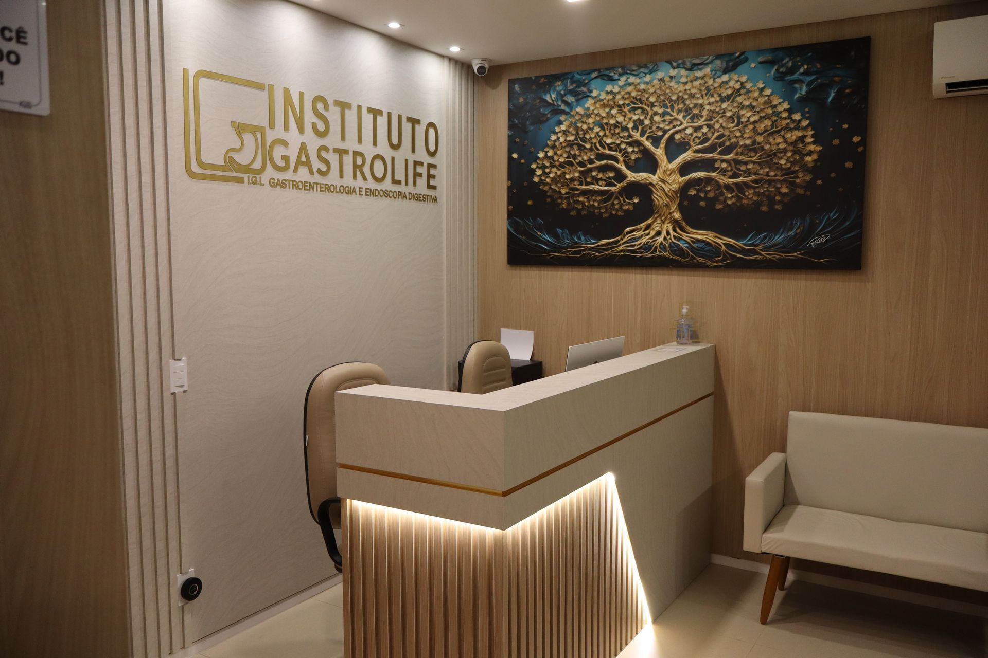 There is a painting of a tree on the wall above the reception desk.