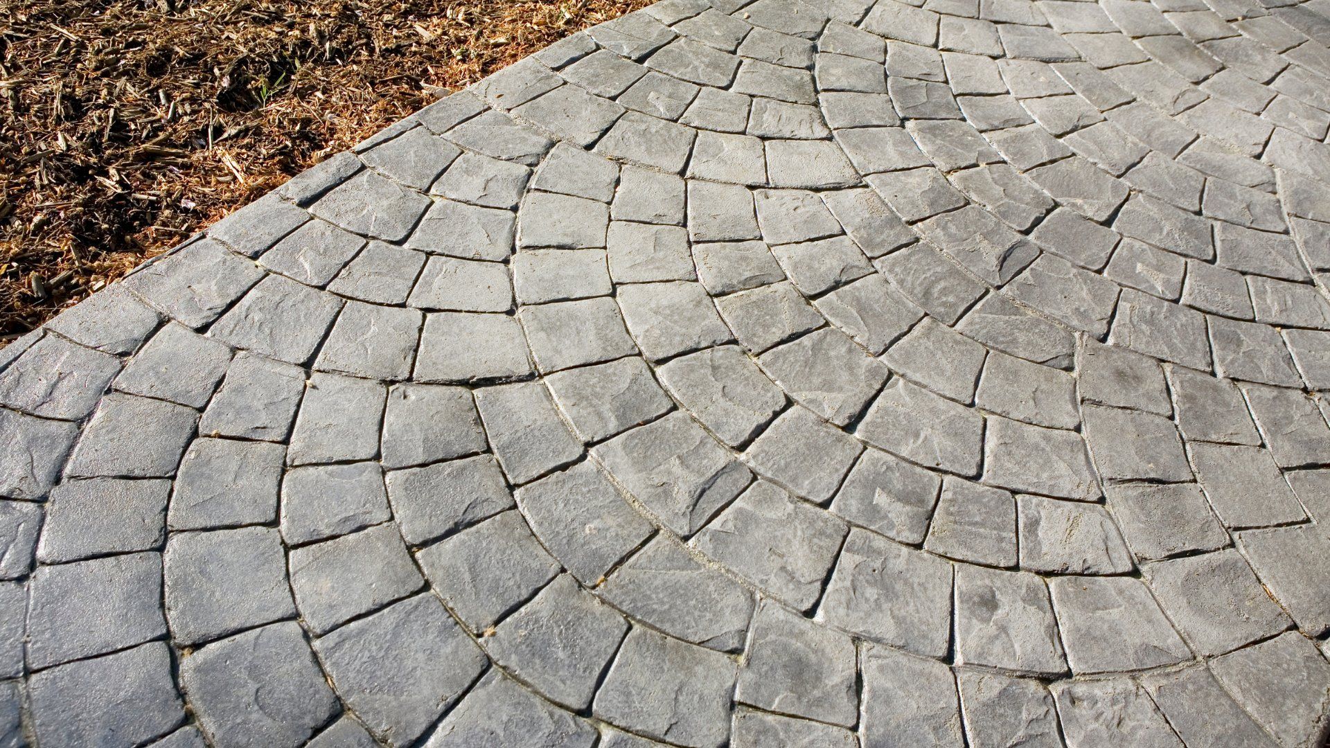 Closeup picture of a stamped concrete patio and walkway.