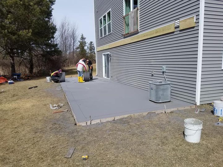 This is a picture of a concrete slab on grade.   It is a new concrete patio outside of a house on top of a hill in Kingston Ontario.