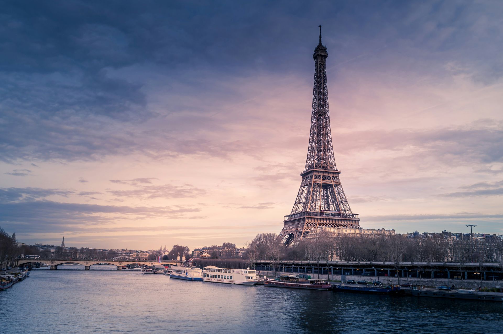 The Eiffel Tower seen from across the Seine at dusk
