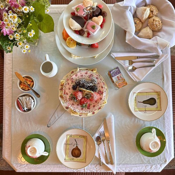 A table topped with plates of food including a cake