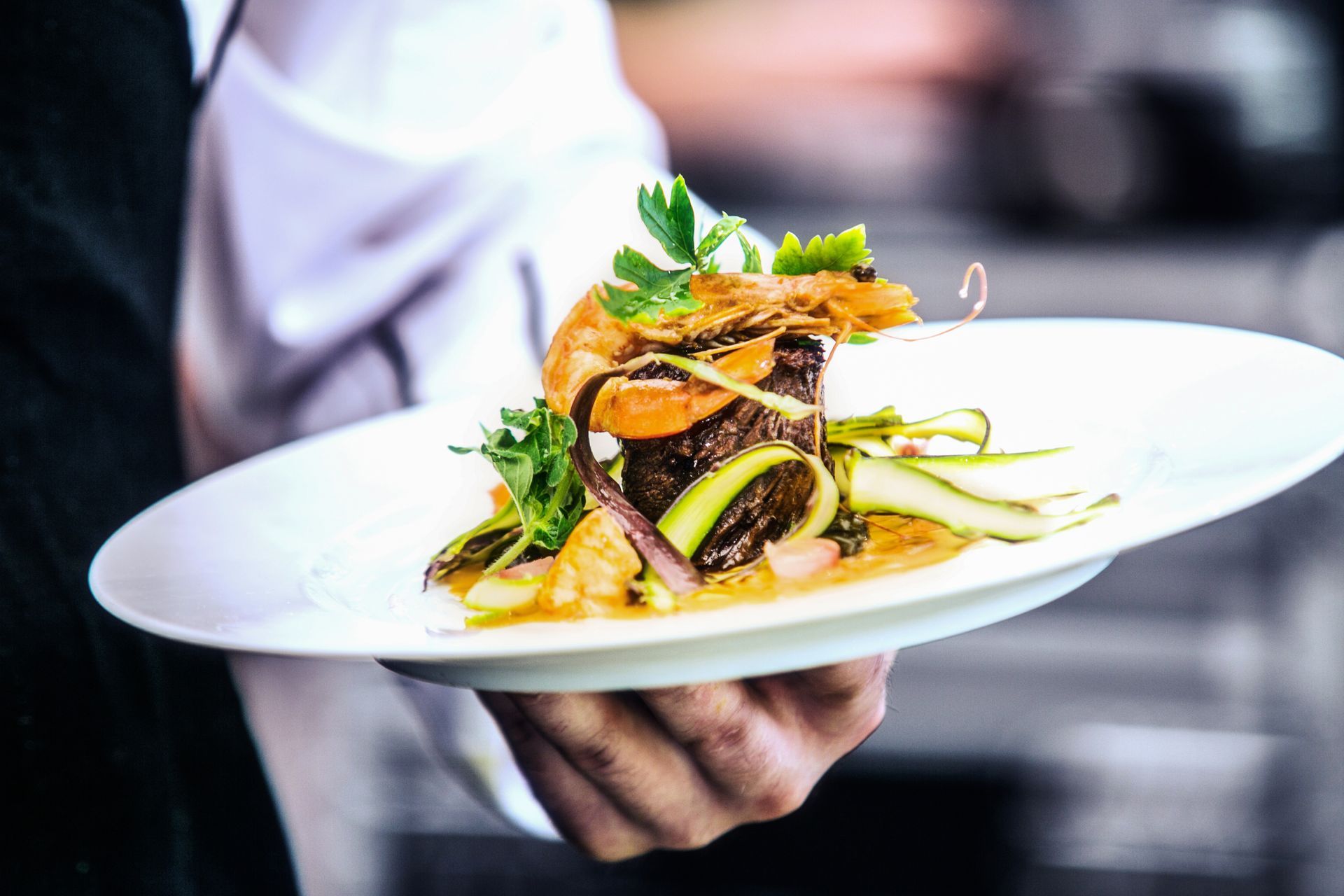 A person is holding a plate of food in their hands.