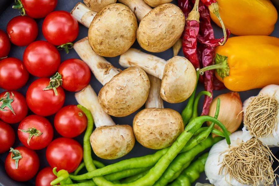 a variety of vegetables including tomatoes mushrooms peppers and garlic