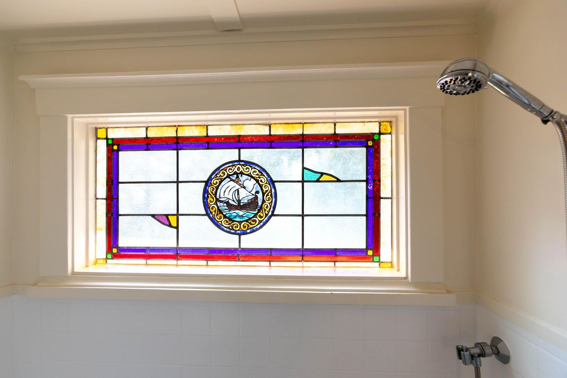 a stained glass window with a ship in the middle