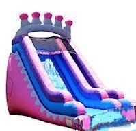 A pink and purple inflatable water slide with a crown on top.