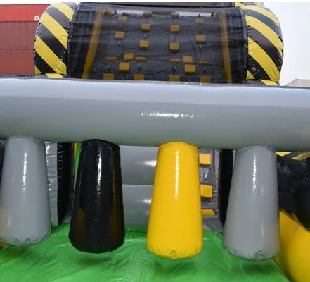 A large inflatable obstacle Full Throttle slide w obstacle course with black and yellow stripes on it