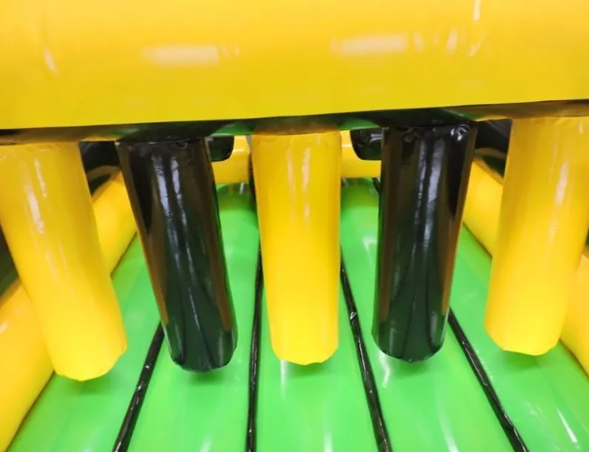 A close up of a yellow, black. and green Full Throttle inflatable obstacle in the Full Throttle course.