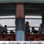 A group of people are sitting on a roller coaster.