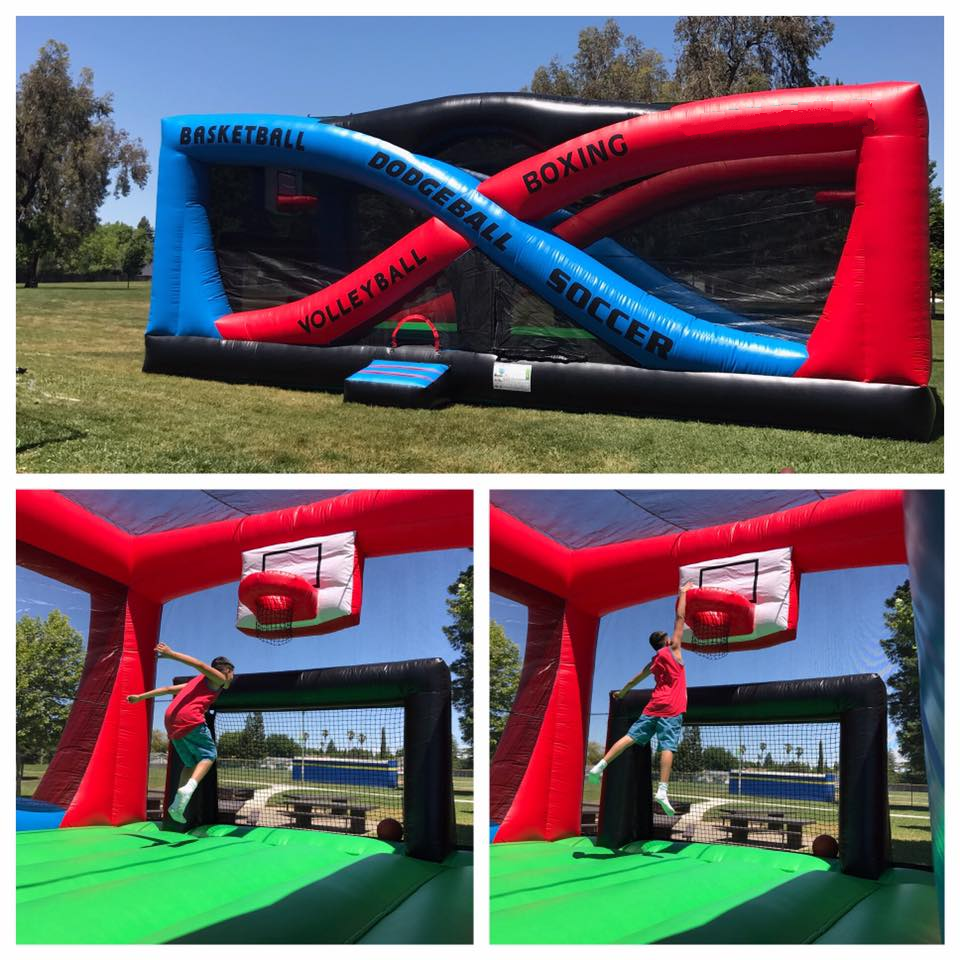 A boy is jumping over an inflatable basketball hoop.