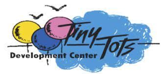 A logo for tiny tots development center with balloons and birds.