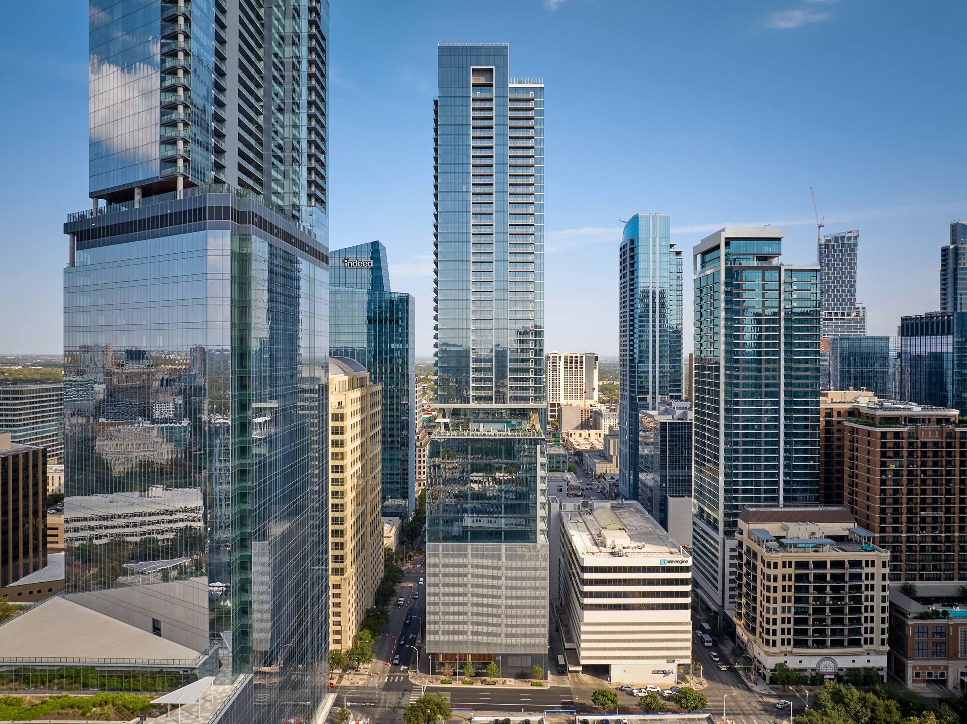 City skyline with tall, modern skyscrapers, a mix of glass and stone.