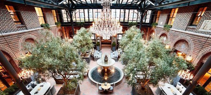 A large building with a fountain in the middle of it.