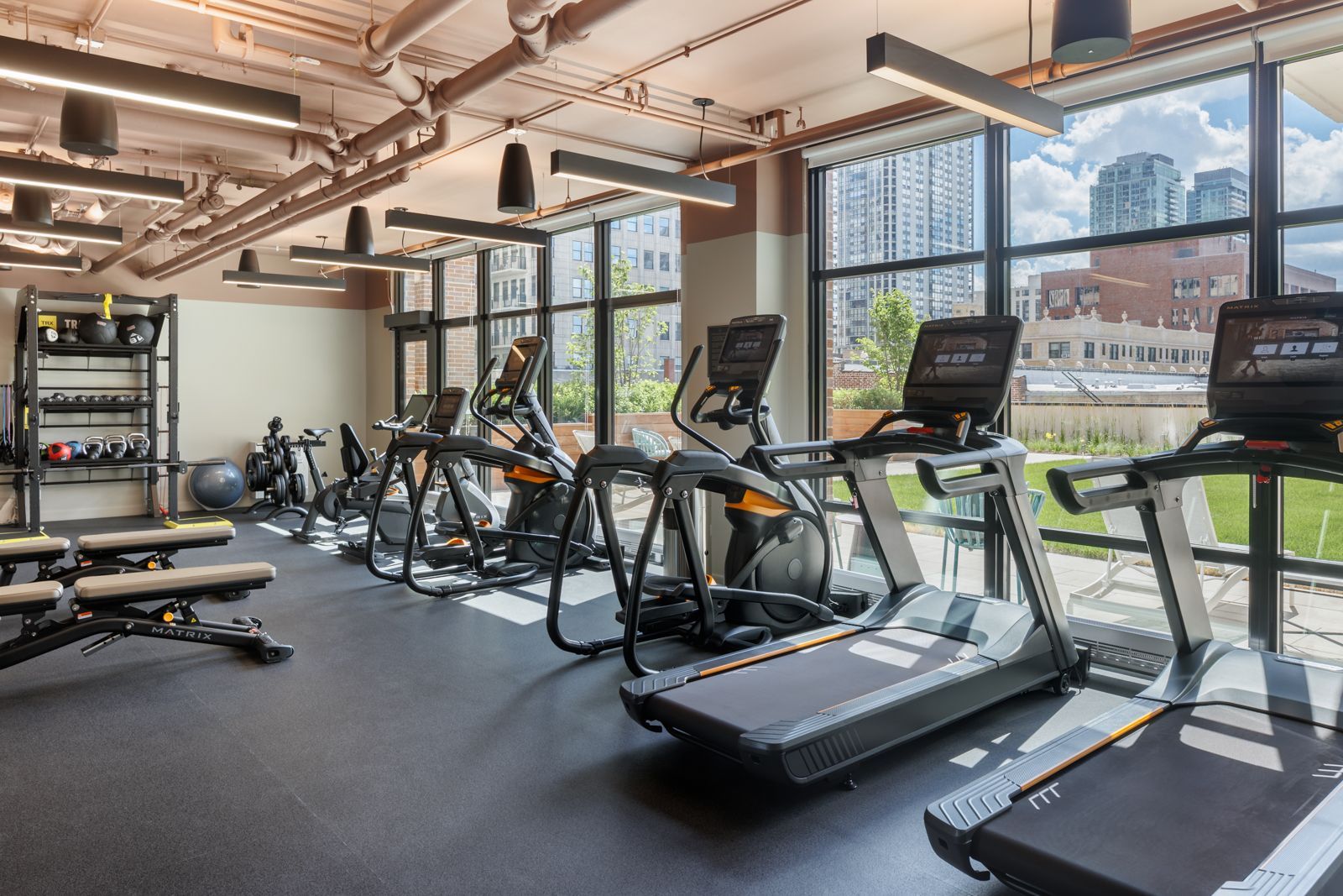 Apartment community fitness center with machines at Gild Apartment.